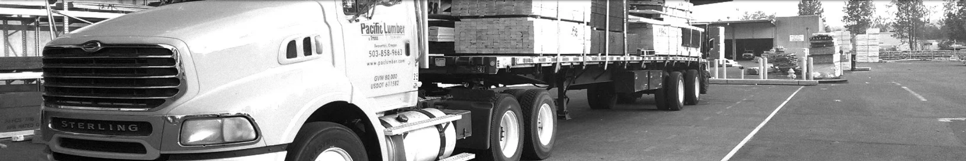 Black and white loaded Pacific Lumber truck